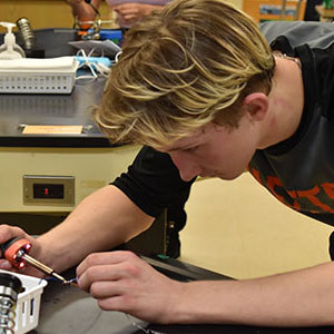 close up picture of a student soldering.